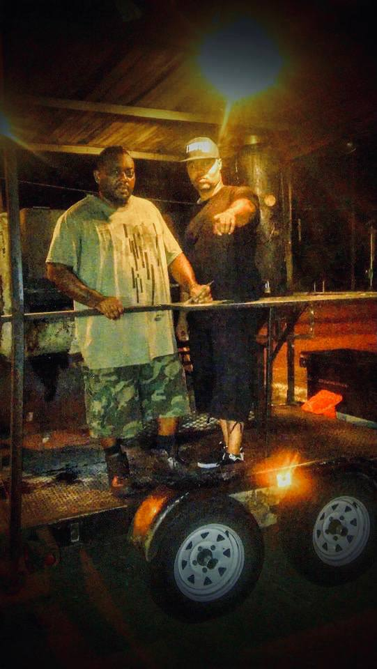 Go Hard Grills crew on the smoker trailer at night
